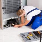 Male Technician Checking Refrigerator